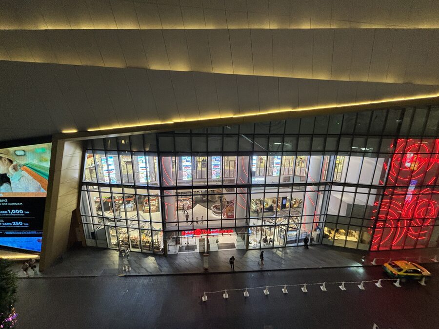 The illuminated glass frontage of ICONSIAM in the evening
